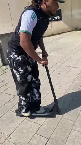 Man rides scooter in outdoor Lyon area