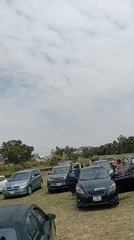 Community gathering with luggage observed in Jos parking area