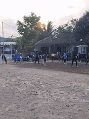 Sunset volleyball on a dirt court in Magelang