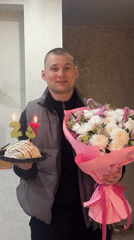 Birthday celebration with cake, flowers documented in Chaikovsky, Russia