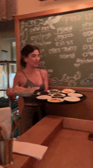 Woman observed at wooden bar in Tel Aviv