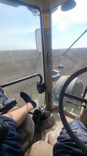 Tractor operator films farmland view in Dobrevo, Bulgaria