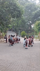 School grounds buzz with students and scooters in Malang