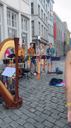 Live harp performance on a cobblestone street in Ghent