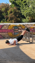 Man performs elevated push-ups using metal stools in Tel Aviv
