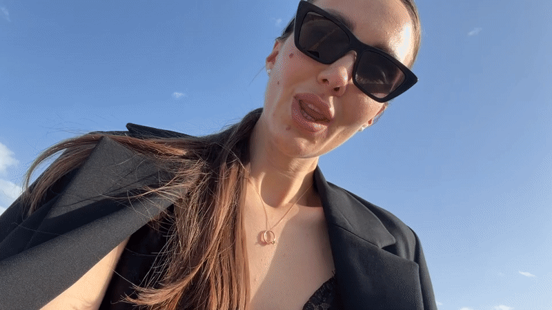 Woman in black blazer observed outdoors in sunny Milas