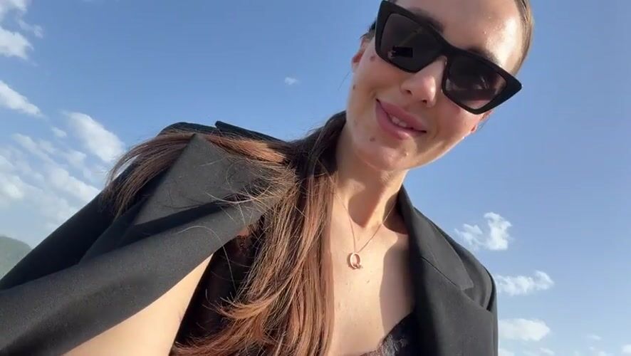Woman in black blazer observed outdoors in sunny Milas