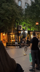 Unicyclist juggles fire and eats flames for Sofia street crowd