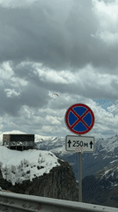 Red paraglider spotted over snowy Gudauri mountains, Georgia