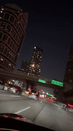 Late-night highway drive through downtown LA's illuminated skyline