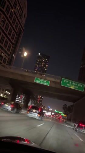 Late-night highway drive through downtown LA's illuminated skyline
