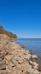 Person in protective gear explores rocky coastline in Noviy