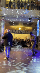 Two men perform live music on mall stage