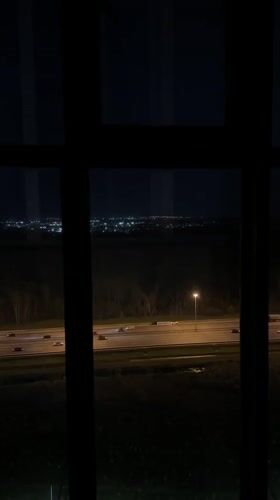 Night cityscape viewed through window in Novosergievka, Russia