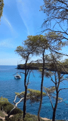 Cala Mondragó bay views from the cliffs, boats anchored below