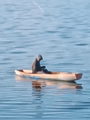 Solitary figure sits in small boat near Lhokseumawe