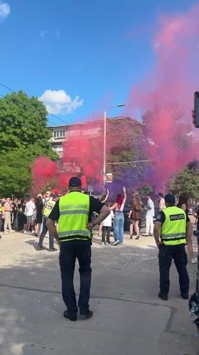 Police monitor street gathering with smoke in Ruse, Bulgaria