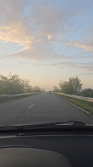 Car travels rural road in Sarnevo, Bulgaria early morning
