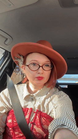 Woman in feathered hat, period costume observed in Yekaterinburg car