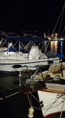 Nighttime marina scene in Limenas Markopoulou, Greece