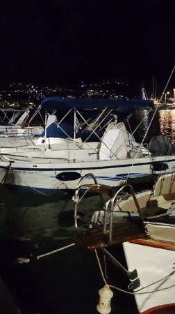 Nighttime marina scene in Limenas Markopoulou, Greece