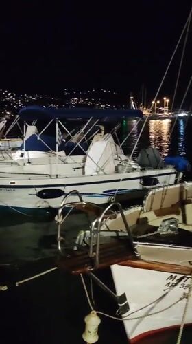 Nighttime marina scene in Limenas Markopoulou, Greece