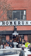 Man performs handstand on pull-up bar outside NYC building