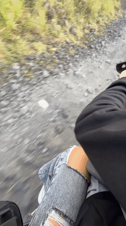 Motorcyclist rides dirt road in rural Kintamani, Indonesia