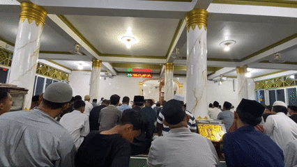 Men gather for midday prayers at Lhokseumawe mosque