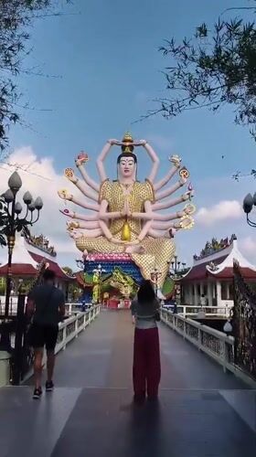 Morning visitors explore Wat Plai Laem Buddhist temple complex Thailand