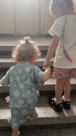 Children in pajamas walk through Bulgarian town streets