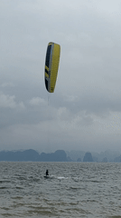 Kitesurfer glides across choppy waters in Bai Chay Ward