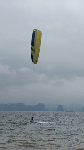 Kitesurfer glides across choppy waters in Bai Chay Ward
