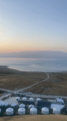 Yurt camp at golden hour, lakeside Kyrgyzstan