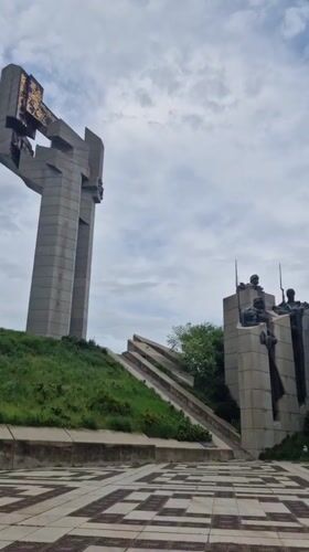 Grey concrete monument with gold elements documented in Bulgaria