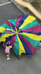 Kids and adults play parachute games outdoors in Ternopil