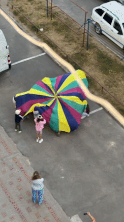 Kids and adults play parachute games outdoors in Ternopil