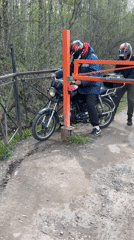 Motorcyclists gather near closed bridge barrier in Russia