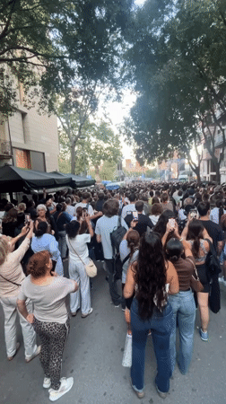 Crowd gathers in Barcelona to watch religious ceremony on outdoor screens