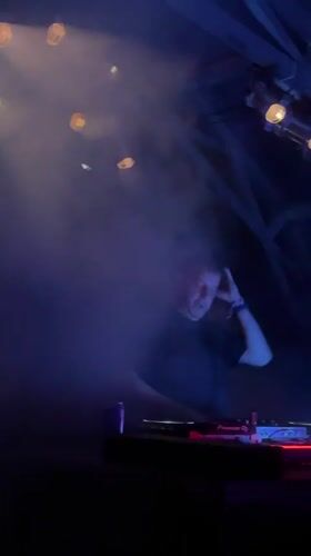 DJ set under colored lights at a Serbian nightclub