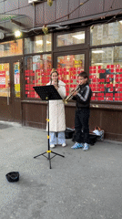 Street musicians perform trumpets outside Saint Petersburg store