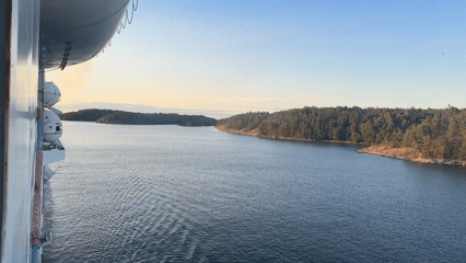 Cruise ship passes sailboats through Nynäshamn archipelago