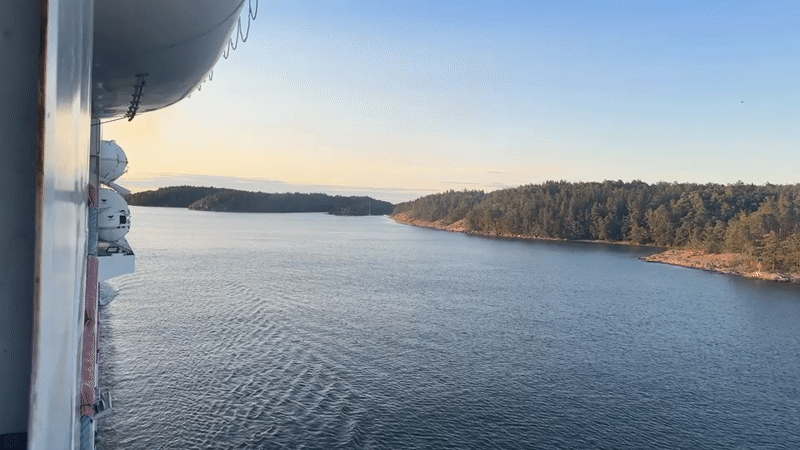 Cruise ship passes sailboats through Nynäshamn archipelago