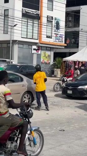 Rollerbladers navigate busy street in Lekki, Nigeria