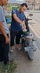 Daily life captured on Lhokseumawe streets: cycling, refueling