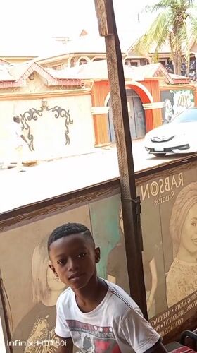 Ordinary street life documented across Nigerian neighborhoods during midday