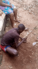Man processes coconut outdoors in Ukwu-Abwa, Nigeria