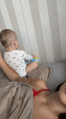 Mother and baby share quiet morning moments in Fredenbeck bedroom