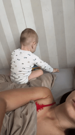Mother and baby share quiet morning moments in Fredenbeck bedroom