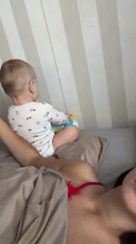 Mother and baby share quiet morning moments in Fredenbeck bedroom